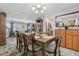 Dining area with a wood table set for six adjacent to the living area at 934 Tall Pine Dr, Port Orange, FL 32127