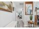 Bright hallway with a decorative mirror, artwork, and a view of the open living space at 934 Tall Pine Dr, Port Orange, FL 32127