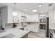 Bright kitchen with white cabinets, light countertops, stainless steel appliances, and tile backsplash at 934 Tall Pine Dr, Port Orange, FL 32127