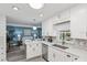 Modern white kitchen with stainless steel appliances, white countertops, and gray backsplash at 934 Tall Pine Dr, Port Orange, FL 32127
