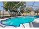A crystal-clear in-ground pool is enclosed in a screened lanai at 934 Tall Pine Dr, Port Orange, FL 32127