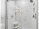 The pristine marble tile shower stall has seamless glass enclosure and niche for toiletries at 934 Tall Pine Dr, Port Orange, FL 32127