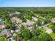 Aerial view of the property with lush landscaping and a community pool at 1 Tomoka Oaks Blvd # 135, Ormond Beach, FL 32174