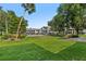 Serene backyard with lush green lawn and tropical landscaping overlooking the community pool at 1 Tomoka Oaks Blvd # 135, Ormond Beach, FL 32174