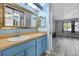 Bathroom with blue vanity and sink with view into the bedroom at 1 Tomoka Oaks Blvd # 135, Ormond Beach, FL 32174