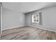 Bright bedroom with stylish wood-look floors and a large window at 1 Tomoka Oaks Blvd # 135, Ormond Beach, FL 32174