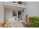 Welcoming entrance with a screen door, window, and beautiful plants at 1 Tomoka Oaks Blvd # 135, Ormond Beach, FL 32174
