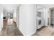 Hallway view highlighting flooring, leading to living area and laundry closet with a modern white washer and dryer at 1 Tomoka Oaks Blvd # 135, Ormond Beach, FL 32174