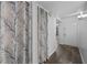 Hallway featuring hardwood flooring, entry door, closet space with curtain divider at 1 Tomoka Oaks Blvd # 135, Ormond Beach, FL 32174