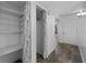Hallway entrance with view of closet featuring wood shelving and hardwood floors at 1 Tomoka Oaks Blvd # 135, Ormond Beach, FL 32174