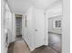 Hallway with closet and doorway with view into bedroom showcasing natural light from the window at 1 Tomoka Oaks Blvd # 135, Ormond Beach, FL 32174