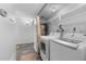 Bright laundry area featuring modern white washer and dryer and shelving for organized storage at 1 Tomoka Oaks Blvd # 135, Ormond Beach, FL 32174