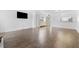 Open-concept living room showcases hardwood flooring and connectivity to other areas of the home at 1 Tomoka Oaks Blvd # 135, Ormond Beach, FL 32174