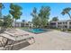 Community pool with lounge chairs and meticulously maintained landscaping creates a refreshing outdoor space at 1 Tomoka Oaks Blvd # 135, Ormond Beach, FL 32174