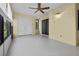 Well-lit sun room with ceiling fan and large windows looking out to the garden at 1 Tomoka Oaks Blvd # 135, Ormond Beach, FL 32174