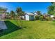 Large backyard featuring a lush green lawn and a shed providing ample storage space at 129 Dundee Rd, Daytona Beach, FL 32118