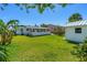 Spacious backyard featuring a shed, a well maintained lawn, and tropical landscaping at 129 Dundee Rd, Daytona Beach, FL 32118