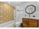 Updated bathroom with colorful tile accent wall, white subway tile, and modern fixtures at 129 Dundee Rd, Daytona Beach, FL 32118