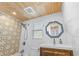 Bathroom showcasing wood paneled ceiling, geometric wall tile, and a octagonal mirror at 129 Dundee Rd, Daytona Beach, FL 32118