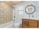 Stylish bathroom features a modern vanity, octagonal mirror, and decorative wall tile at 129 Dundee Rd, Daytona Beach, FL 32118