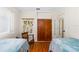 Shared bedroom featuring hardwood floors, comfortable rocking chair and cozy vibe at 129 Dundee Rd, Daytona Beach, FL 32118