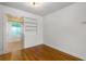 Bright bedroom with hardwood floors, built in shelves, and neutral paint scheme at 129 Dundee Rd, Daytona Beach, FL 32118
