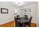 Cozy dining room with hardwood floors, built-in shelving, and a view to the kitchen at 129 Dundee Rd, Daytona Beach, FL 32118
