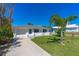 Inviting home showcasing a lush lawn, complemented by mature trees and a well-kept exterior at 129 Dundee Rd, Daytona Beach, FL 32118