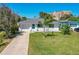 Charming single-story home with well-maintained lawn and landscaping, showcasing curb appeal and inviting aesthetics at 129 Dundee Rd, Daytona Beach, FL 32118