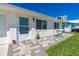 Close up of a welcoming front porch area featuring modern paving stones and vibrant potted plants at 129 Dundee Rd, Daytona Beach, FL 32118