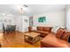 Bright living room featuring a large leather sofa, hardwood floors, and stylish decor at 129 Dundee Rd, Daytona Beach, FL 32118