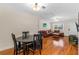 Open-concept living and dining area with hardwood floors, a leather sofa, and modern lighting at 129 Dundee Rd, Daytona Beach, FL 32118