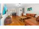 Cozy living room featuring a comfortable leather sofa and gleaming hardwood floors at 129 Dundee Rd, Daytona Beach, FL 32118