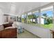 Relaxing screened-in porch with comfortable seating, offering a perfect spot to enjoy the outdoors in comfort at 129 Dundee Rd, Daytona Beach, FL 32118