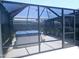 Enclosed backyard spa area with covered hot tub is enhanced by a screened enclosure, with lighting for ambiance at 13 Sunrise Ave, Ormond Beach, FL 32176