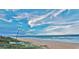 Tranquil beach scene with a sailboat and clear blue skies at 13 Sunrise Ave, Ormond Beach, FL 32176