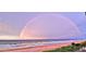 Beautiful beach view featuring a rainbow arc over the ocean at 13 Sunrise Ave, Ormond Beach, FL 32176