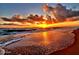 Stunning sunrise on the beach with rolling waves and vibrant, cloud-filled sky providing a serene coastal atmosphere at 13 Sunrise Ave, Ormond Beach, FL 32176