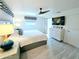 Bright bedroom with a ceiling fan, TV, and a sliding door, creating a relaxing retreat at 13 Sunrise Ave, Ormond Beach, FL 32176