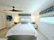 Bright bedroom with comfortable queen bed, stylish artwork, and modern window treatments at 13 Sunrise Ave, Ormond Beach, FL 32176