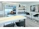 Open-concept dining area with modern lighting, breakfast bar, and views into the living space at 13 Sunrise Ave, Ormond Beach, FL 32176