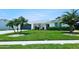 Charming coastal home with lush lawn, palm trees, and a welcoming front porch at 13 Sunrise Ave, Ormond Beach, FL 32176