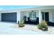Inviting front porch with comfortable seating, stylish lighting, and manicured landscaping at 13 Sunrise Ave, Ormond Beach, FL 32176