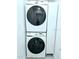 Convenient laundry area featuring stacked Samsung washer and dryer units and built in storage at 13 Sunrise Ave, Ormond Beach, FL 32176
