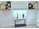Bright living space showcases a console table with decor, a window letting in natural light, and artwork on display at 13 Sunrise Ave, Ormond Beach, FL 32176