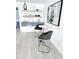 Cozy seating area with modern bar stools, floating shelves and an abstract art piece displayed on the wall at 13 Sunrise Ave, Ormond Beach, FL 32176