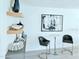 Stylish seating area boasts modern decor, floating shelves with accents, and an abstract art piece on the wall at 13 Sunrise Ave, Ormond Beach, FL 32176