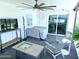Inviting screened-in patio with comfortable seating and an outdoor TV for relaxation and entertainment at 13 Sunrise Ave, Ormond Beach, FL 32176