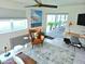 Comfortable sitting area featuring stylish decor, bright windows, and sliding glass door to outdoor space at 13 Sunrise Ave, Ormond Beach, FL 32176