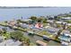 Aerial view of home featuring a private pool, dock, and waterfront access with city skyline views at 136 Reef Rd, South Daytona, FL 32119